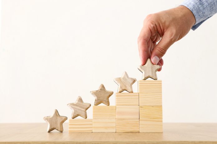 Man placing stars on building blocks