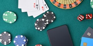 SYNOT Group calls on Playtech for Czech live casino studio Playing cards, poker chips and a mobile phone on a casino table