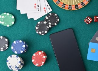 SYNOT Group calls on Playtech for Czech live casino studio Playing cards, poker chips and a mobile phone on a casino table