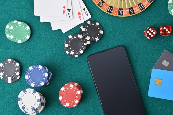 Playing cards, poker chips and a mobile phone on a casino table