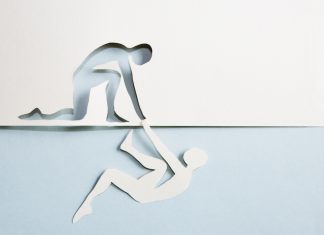 iGaming Daily: A journey from addiction to safer gambling advocacy A man cut out of paper being helped by the cut out of a man made of paper