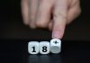 Balatro receives PEGI age rating reduction from 18 to 12 Fingers pushing dice showing 18+