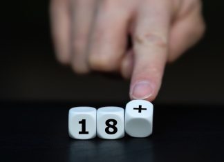 Balatro receives PEGI age rating reduction from 18 to 12 Fingers pushing dice showing 18+
