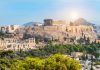 Swintt gets green light to launch in Greece Panoramic view of Athens with Acropolis hill on a hot summer day in Greece.