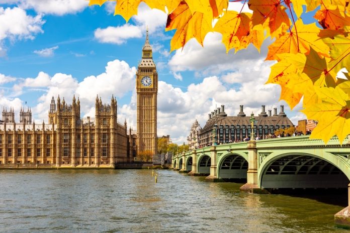 Big Ben with Houses of Parliament and Westminster bridge in autumn, London, UK