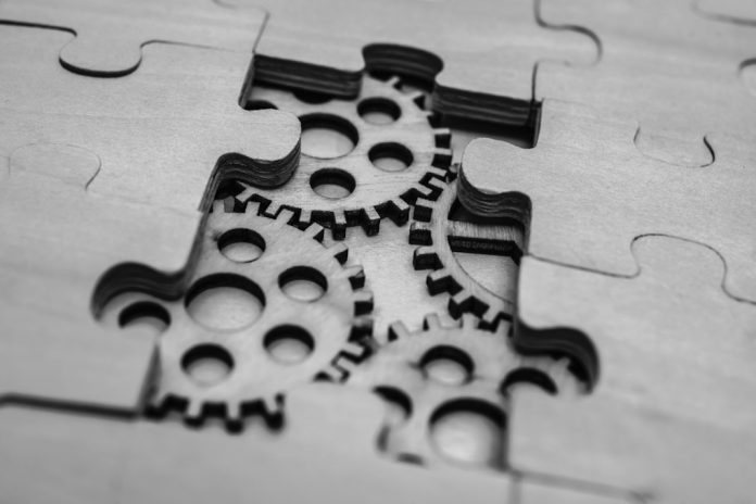 Aggregation Cogs within a jigsaw puzzle to represent aggregation
