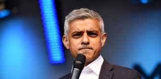 Pressure intensifies for Sadiq Khan over TFL pledge Sadiq Khan holding a microphone