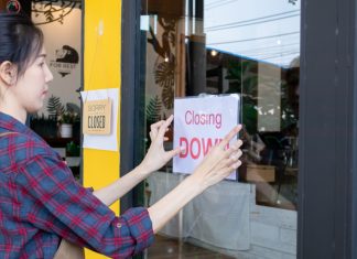 XLMedia proposes £11m tender for shareholders ahead of shutdown Women putting closing down sign on window