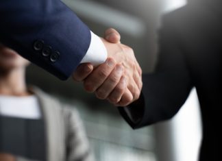 Delta Bingo taps Strive Gaming for digital relaunch Businessmen shaking hands