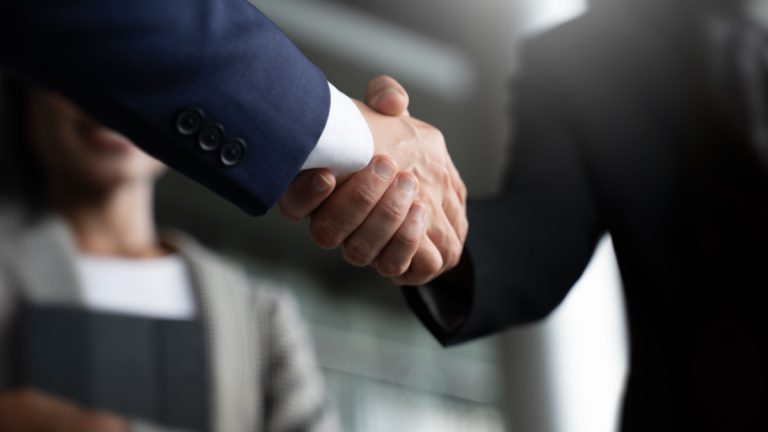 Delta Bingo taps Strive Gaming for digital relaunch Businessmen shaking hands
