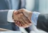 Codere expands in Italy with Codgames stake Businessmen shake hands