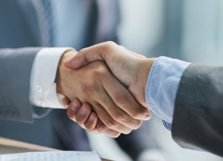 Codere expands in Italy with Codgames stake Businessmen shake hands