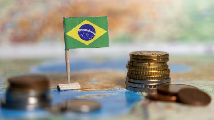 Brazil Brazil flag next to a stack of coins
