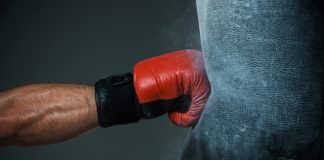 Evolution fights back at regulators in black market dispute A boxing glove punches a punch bag as AUSTRAC fightback against financial crime