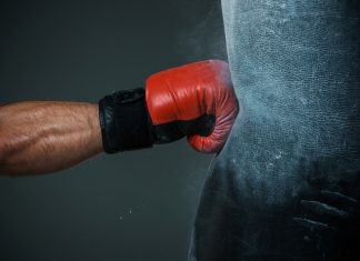 Evolution fights back at regulators in black market dispute A boxing glove punches a punch bag as AUSTRAC fightback against financial crime