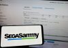 Sega Sammy completes Stakelogic acquisition despite criminality concerns Sega Sammy logo shown on a phone screen