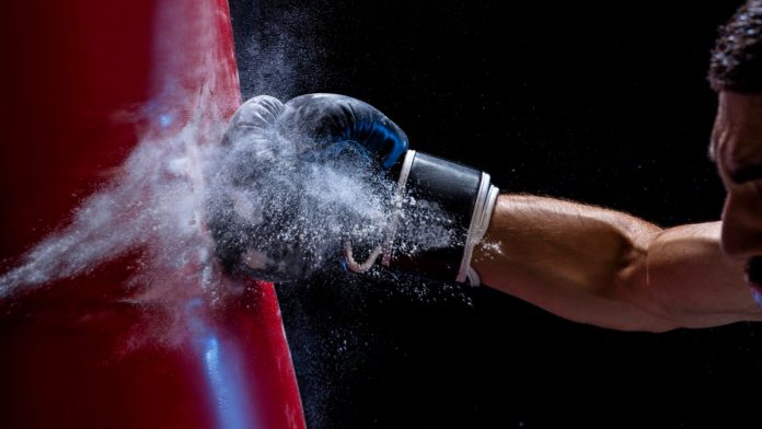 Close up of a fist hitting a punchbag