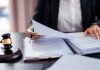 Stake.us embroiled in third sweepstakes lawsuit Lawyer sifts through court documents next to a gavel