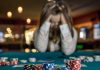 GambleAware: Problem gambling self-referrals increased by 50% Person with head in hands at casino table
