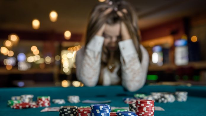 Person with head in hands at casino table