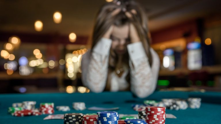 Person with head in hands at casino table