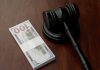 High 5 Games’ Connecticut licence reinstated following $1.5m settlement A gavel sits next to a stack of bank notes, indicating a settlement has been reached