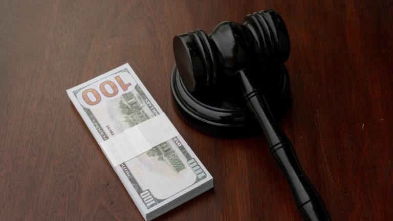 High 5 Games’ Connecticut licence reinstated following $1.5m settlement A gavel sits next to a stack of bank notes, indicating a settlement has been reached