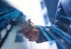 Infingame expands content portfolio with Formula Spin partnership Two businessman shake hands
