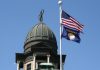Montana on the brink of first US sweeps ban US and Montana state flag on a flagpole attached to a large building