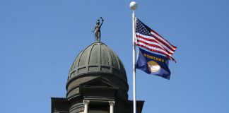Montana on the brink of first US sweeps ban US and Montana state flag on a flagpole attached to a large building