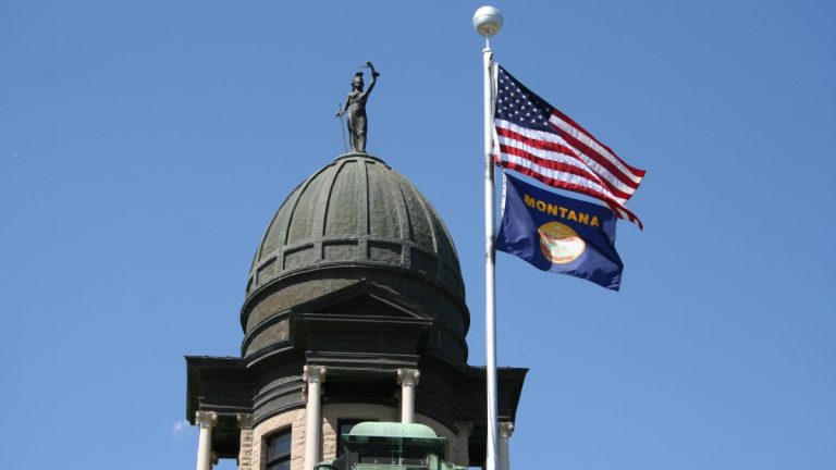 Montana on the brink of first US sweeps ban US and Montana state flag on a flagpole attached to a large building