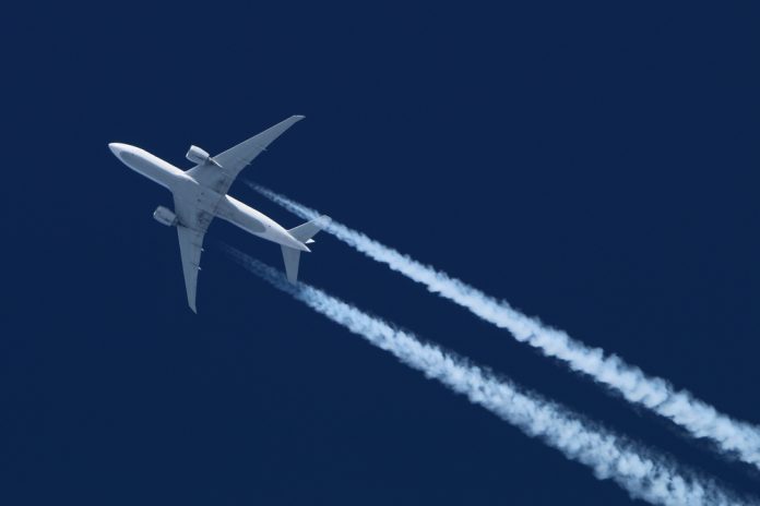 online-casino-soars-denmark A plane soars into the sky with a trail behind it