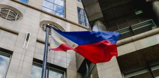PAGCOR issues stark fraudulent license warning Philippines flag waves in the wind