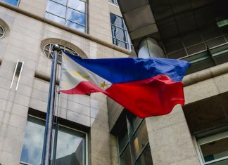 PAGCOR issues stark fraudulent license warning Philippines flag waves in the wind