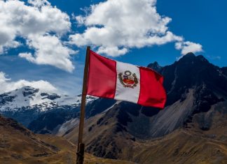 Peru buoyant after first year of new gambling regime Peru flag with a mountain panorama