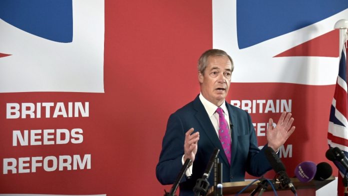 Nigel Farage stands in front of a union jack promoting the reform party