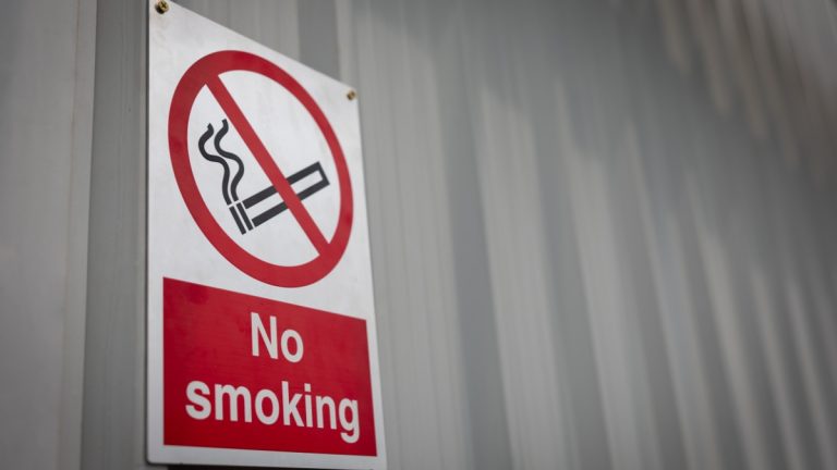 A no smoking sign on a wall, something casino workers in Rhode Island hope to see
