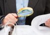 Thailand’s Senate intensifies scrutiny on casino bill Man in suit takes a closer look at papers with a magnifying glass