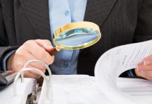 Central Bank calls for junkets to be next in line for Philippines regulatory scrutiny Man in suit takes a closer look at papers with a magnifying glass