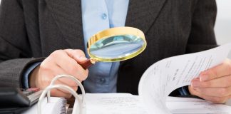 Thailand’s Senate intensifies scrutiny on casino bill Man in suit takes a closer look at papers with a magnifying glass