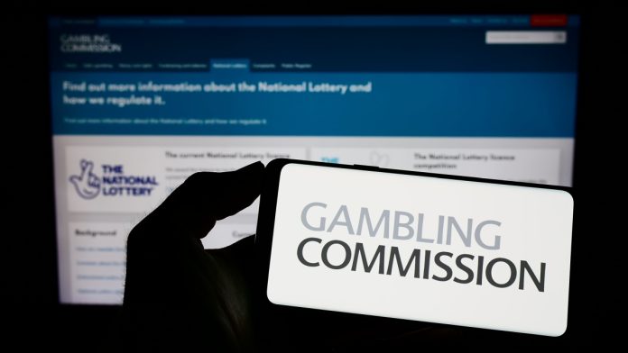 ukgc-gambling-data-financial-profiling Gambling Commission logo on a phone, the body behind the gambling engagement data
