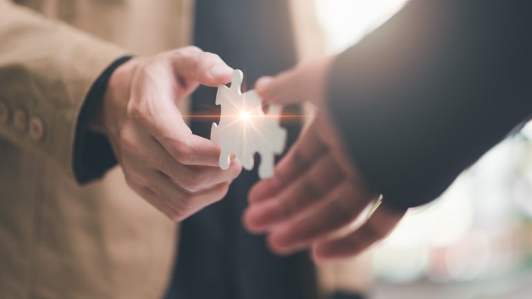 Xanada Investments unveils Tequity strategic partnership Two hands bring together puzzle pieces, indicating a partnership between the two