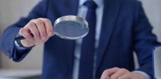 Swedish regulator undergoes compliance review of Svenska Spel Businessman with magnifying glass as AB Trotting and Galloping, Svenska Spel Sport & Casino AB and Lotto Direct Limited will be checked for compliance by the Swedish regulator