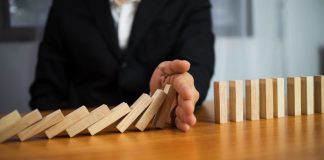 ACMA uncovers self-exclusion failures by four operators A hand stops dominos falling, just as the AMCA has intervened to stop more self exclusion failures