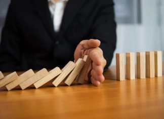 ACMA uncovers self-exclusion failures by four operators A hand stops dominos falling, just as the AMCA has intervened to stop more self exclusion failures