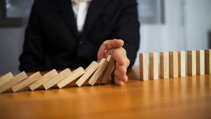 acma-self-exclusion-failures A hand stops dominos falling, just as the AMCA has intervened to stop more self exclusion failures
