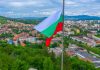 Bulgarian Ministries propose significant online gaming reforms Bulgarian flag sits above a town below