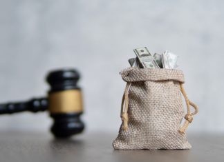 Casino Days hit with AGCO penalty for ‘deceptive’ bonus offer A sack of money next to a gavel, indicating that a financial penalty has been handed out