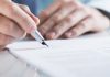 Connecticut edges closer to sweepstakes ban Close up of a mans hands signing a piece of paper