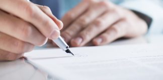 Connecticut edges closer to sweepstakes ban Close up of a mans hands signing a piece of paper